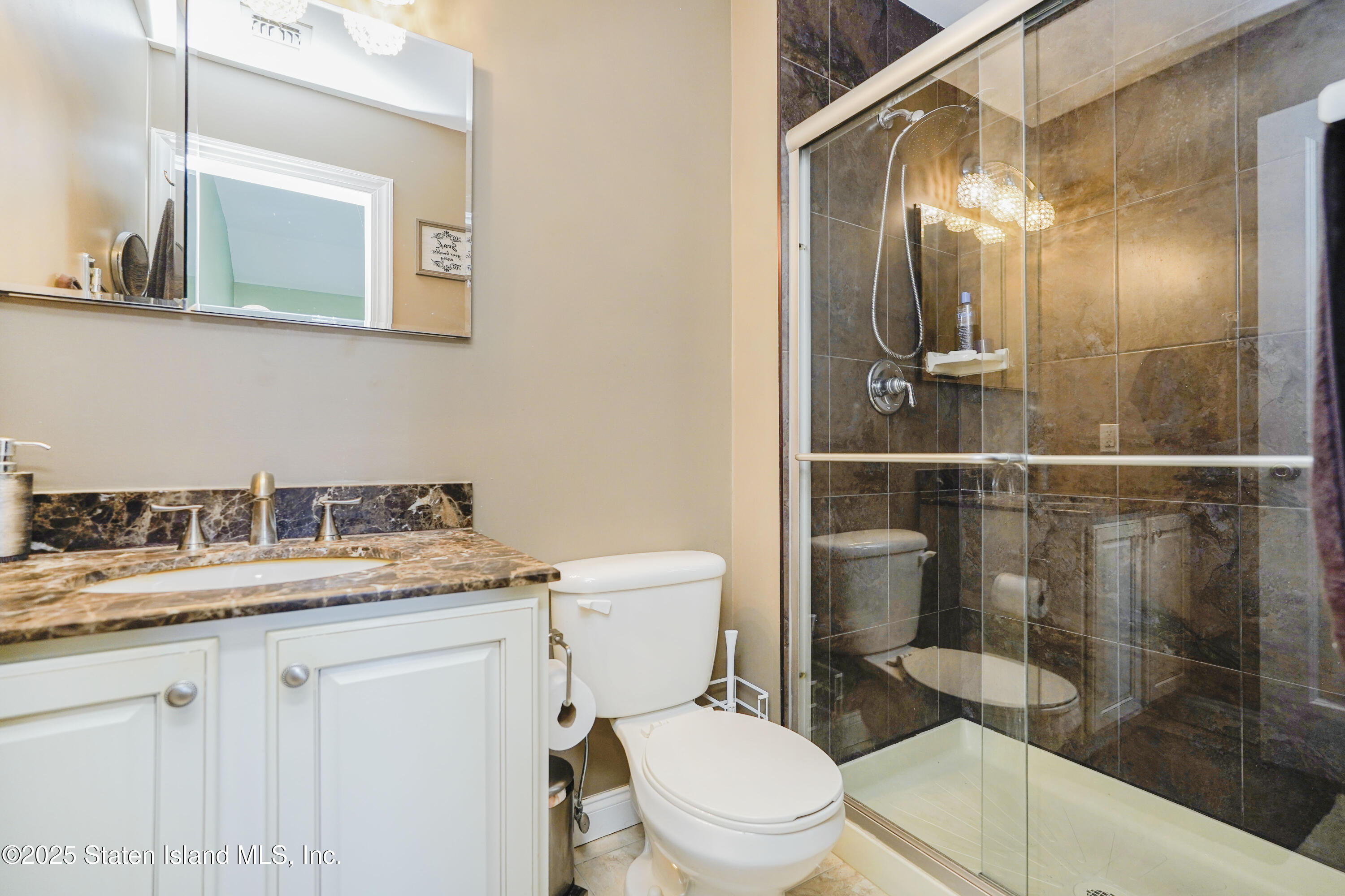 84 Presentation Circle Staten Island, NY 10312 - Photo 19 of 35 a bathroom with a granite countertop sink a toilet and a mirror
