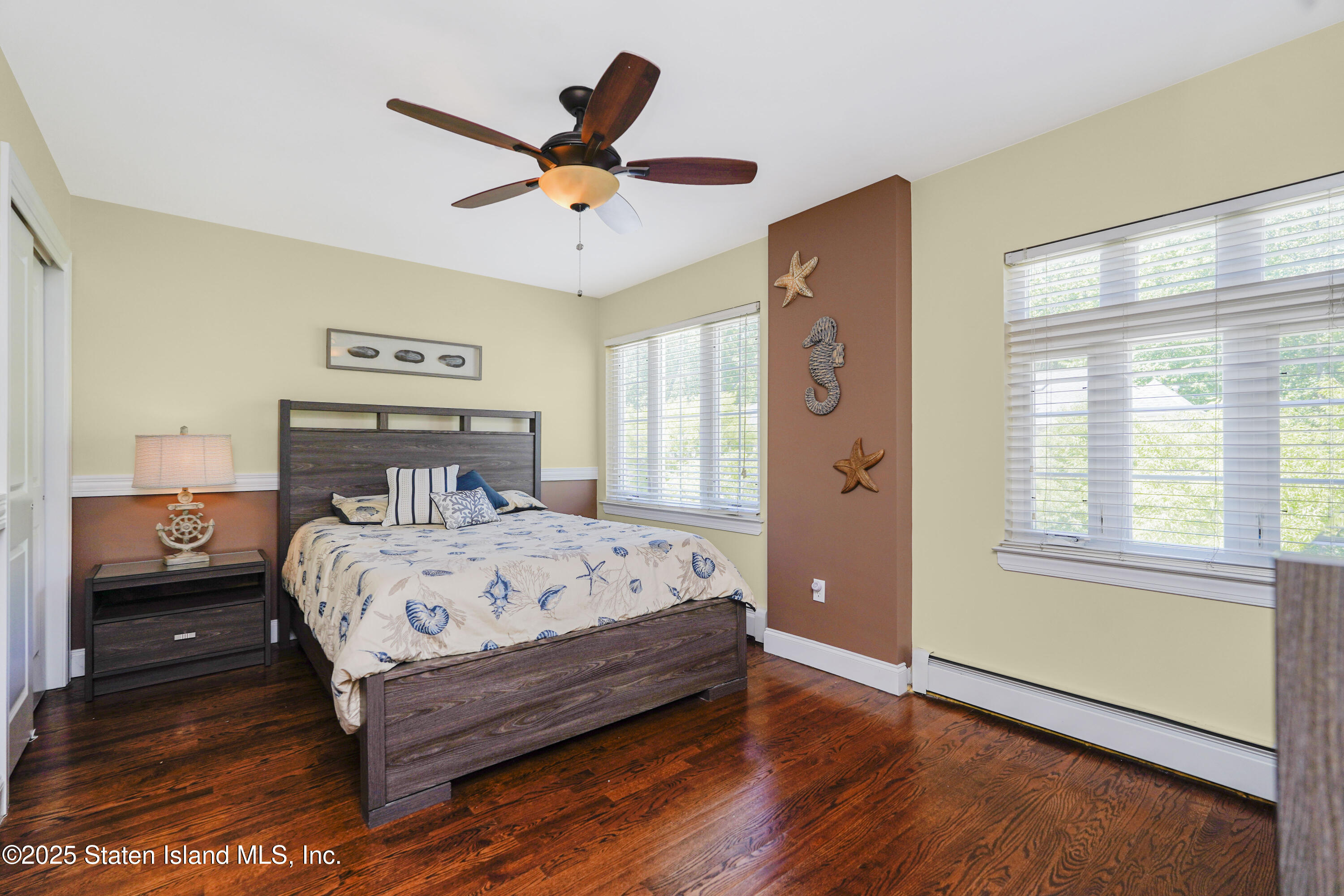 84 Presentation Circle Staten Island, NY 10312 - Photo 22 of 35 a bedroom with a bed and wooden floor