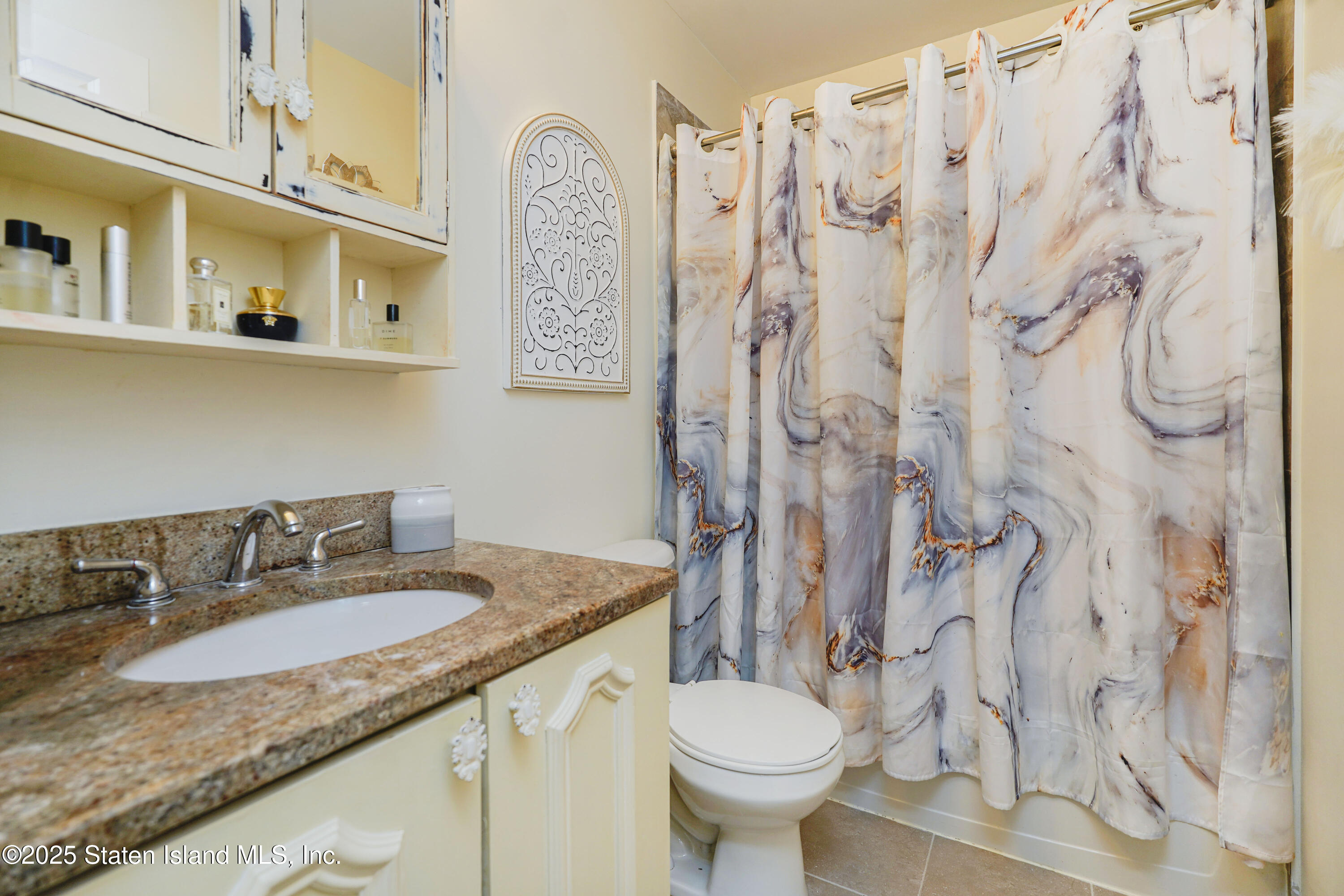 84 Presentation Circle Staten Island, NY 10312 - Photo 23 of 35 a bathroom with a granite countertop sink and a mirror