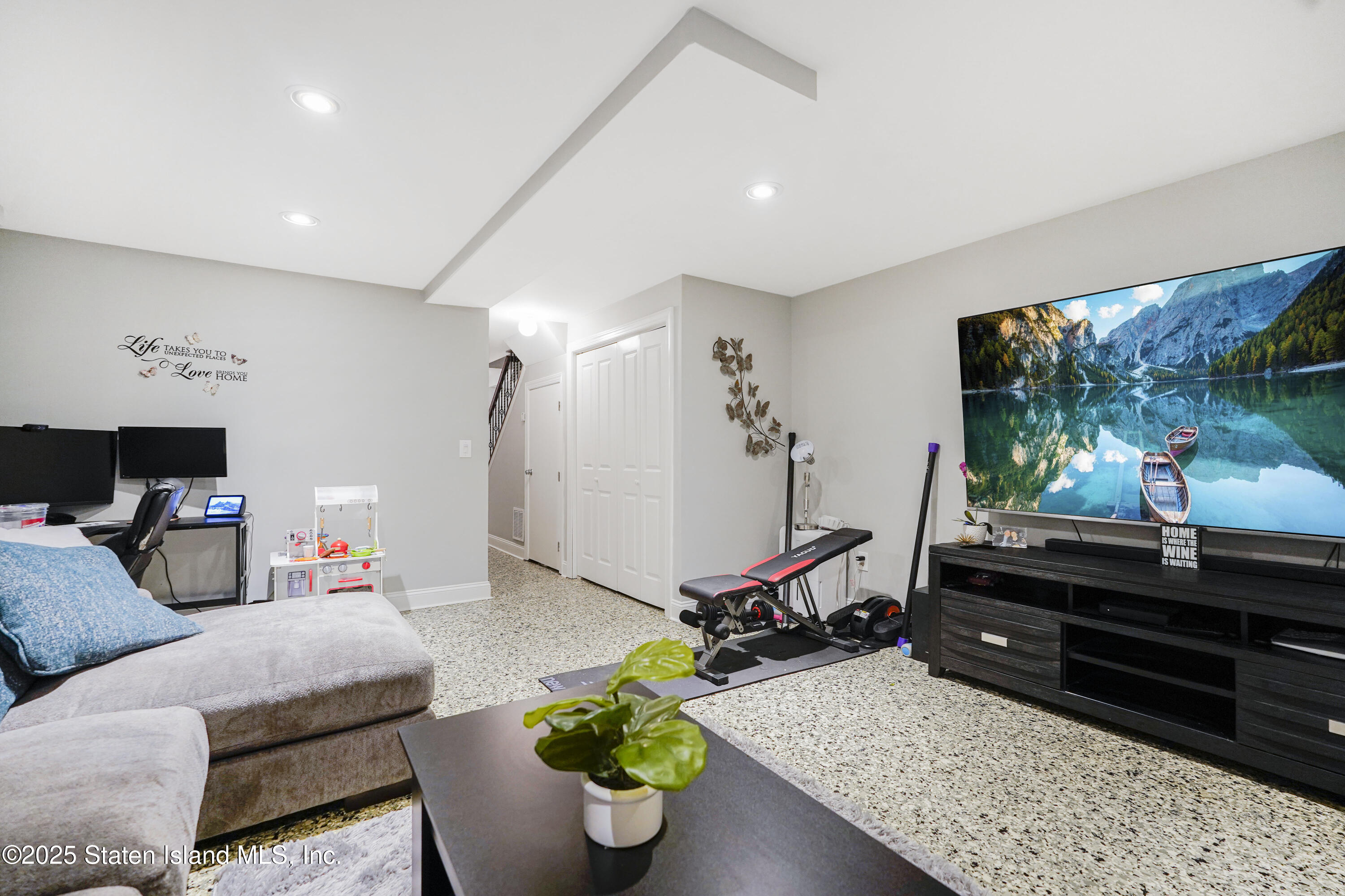 84 Presentation Circle Staten Island, NY 10312 - Photo 27 of 35 a living room with furniture gym equipment and a flat screen tv