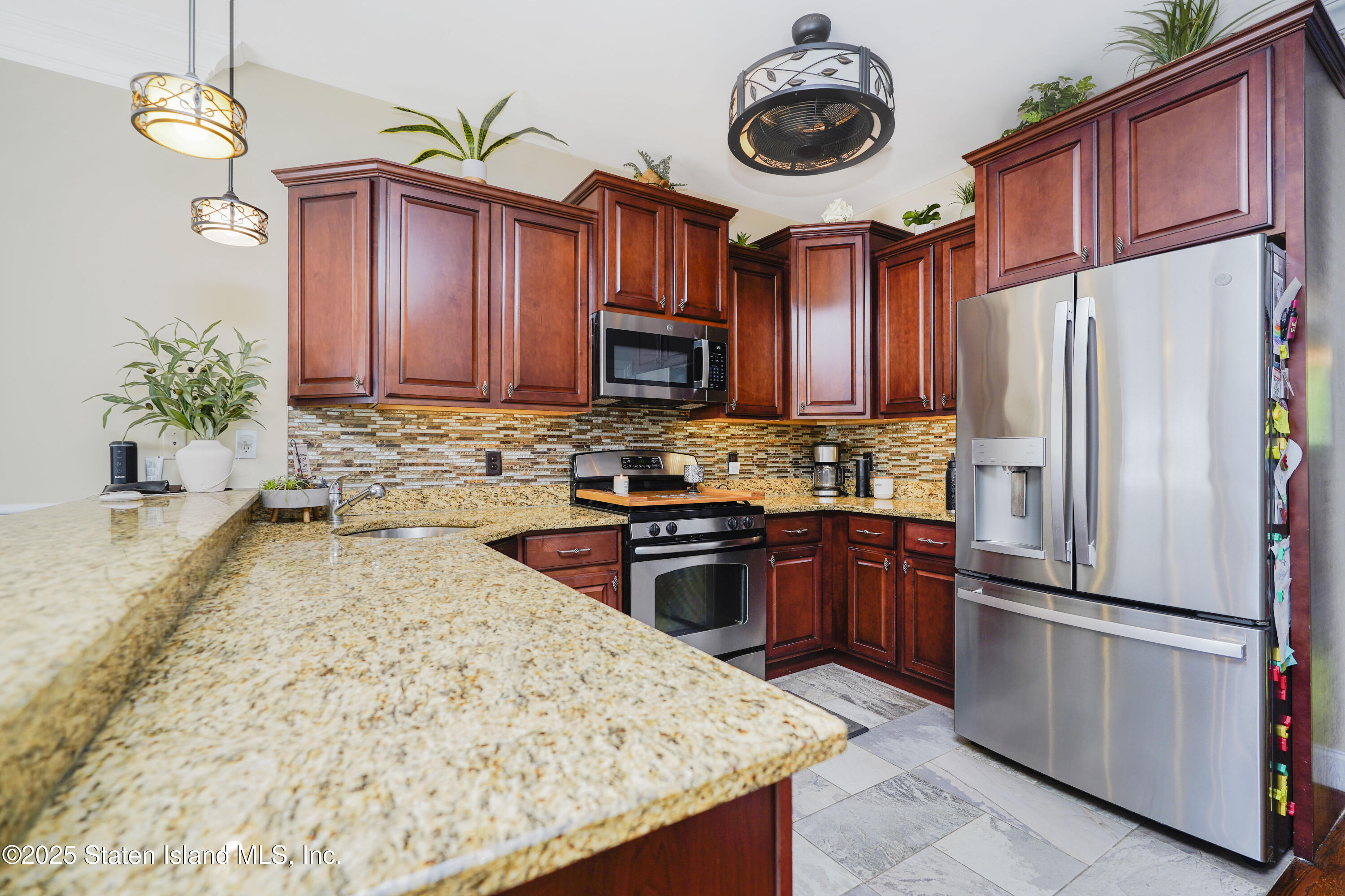 84 Presentation Circle Staten Island, NY 10312 - Photo 8 of 35 a kitchen with stainless steel appliances granite countertop a refrigerator a stove top oven a sink and dishwasher