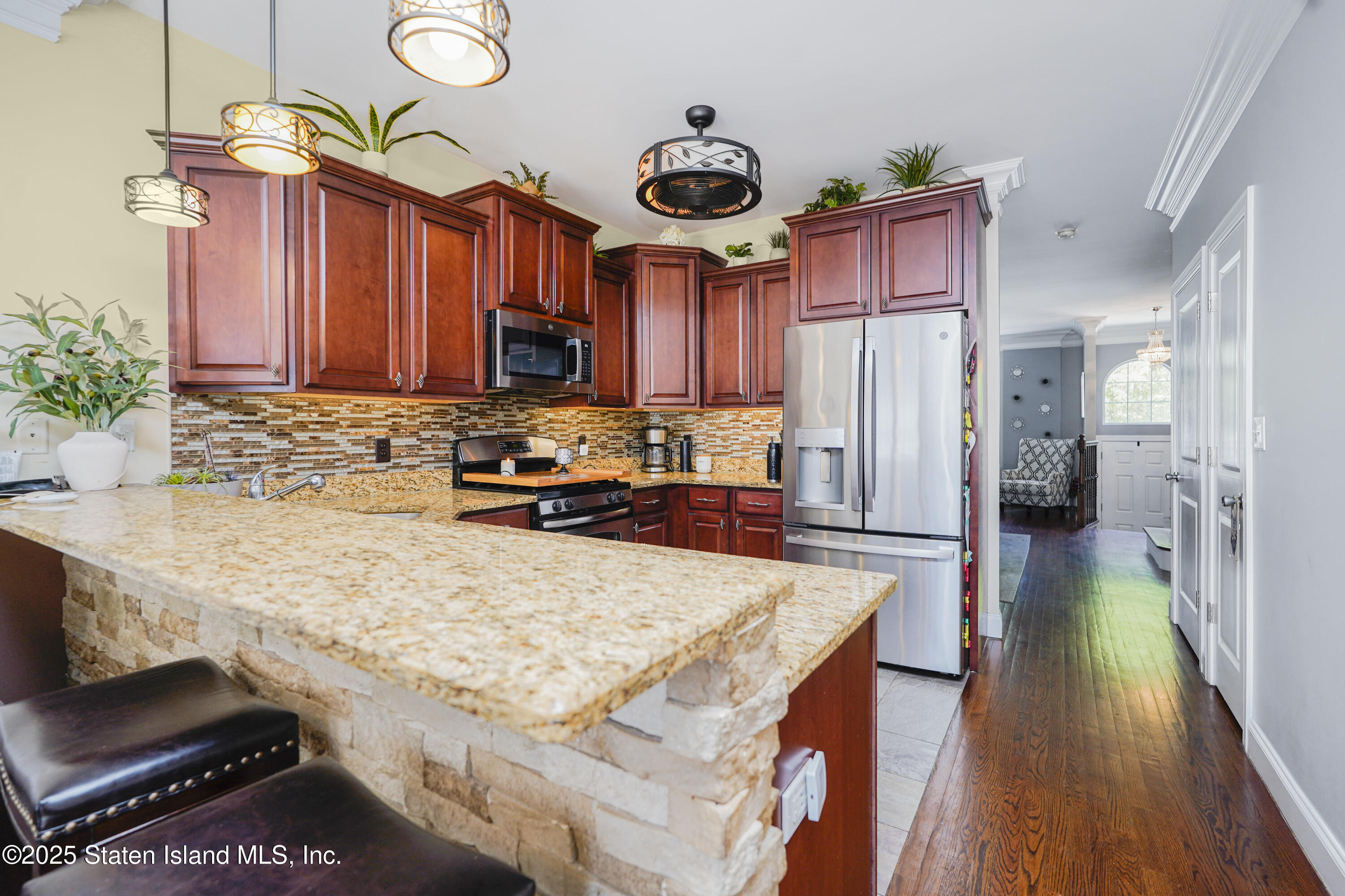 84 Presentation Circle Staten Island, NY 10312 - Photo 10 of 35 a kitchen with a refrigerator a sink and a stove top oven