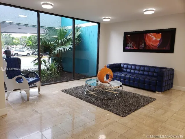 a view of a room with table and chairs