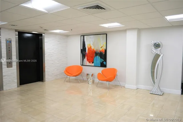 a living room with furniture a lamp and a potted plant