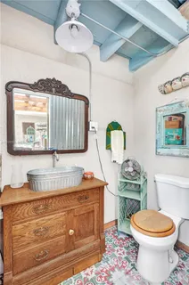 a bathroom with a toilet a sink and mirror