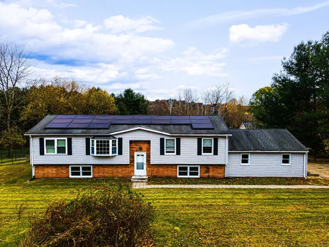 a front view of a house with a yard table and chairs