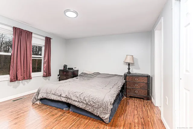 a bathroom with a sink toilet a mirror and shower
