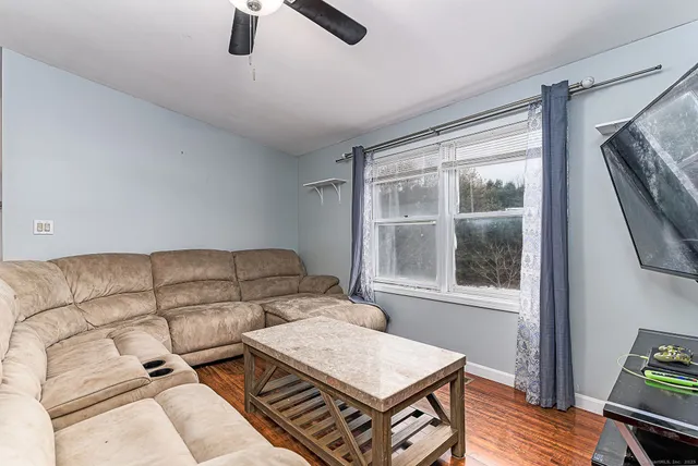 a bedroom with furniture and a wooden floor