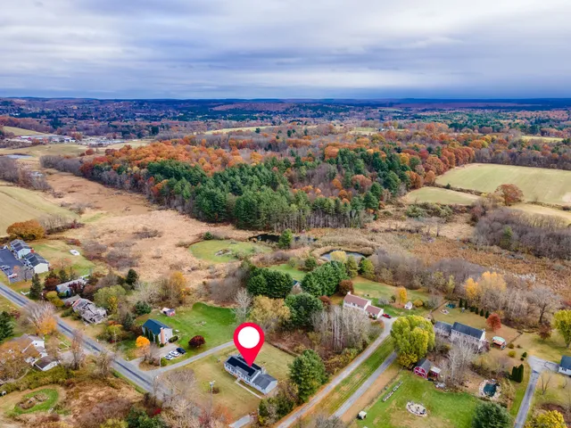 a view of a swimming pool with an outdoor seating and a floor to ceiling window