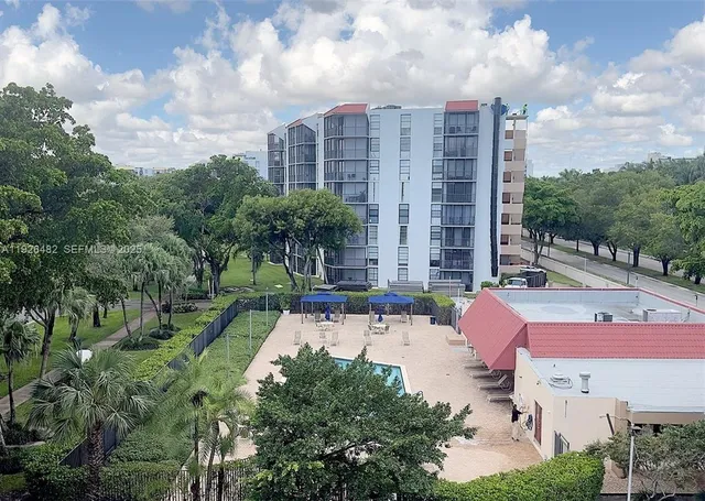a swimming pool with outdoor seating and trees