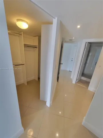 a view of a storage & utility room with refrigerator