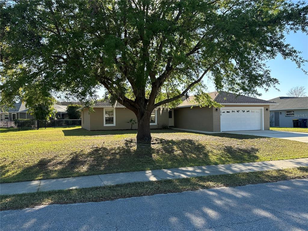 379 Renssalaer Avenue Auburndale, FL 33823 - Photo 1 of 1 a front view of house with yard space and trees in the background