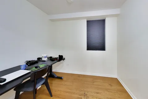 a view of a livingroom with wooden floor and a window