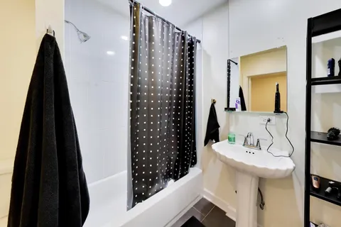 a bedroom with a bed and a chair