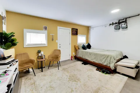 a bedroom with furniture and a window