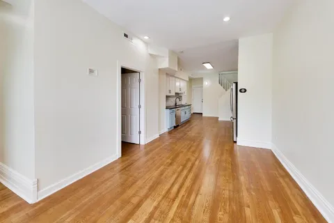 a view of a living room with wooden floor