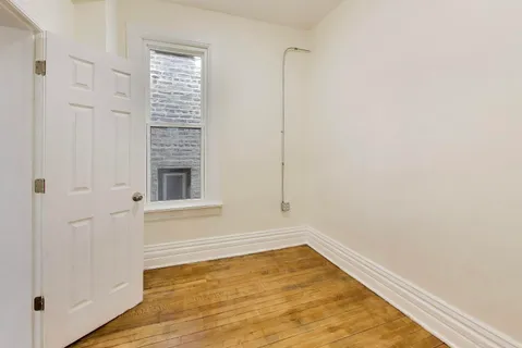 a storage room with wooden floor washer and dryer