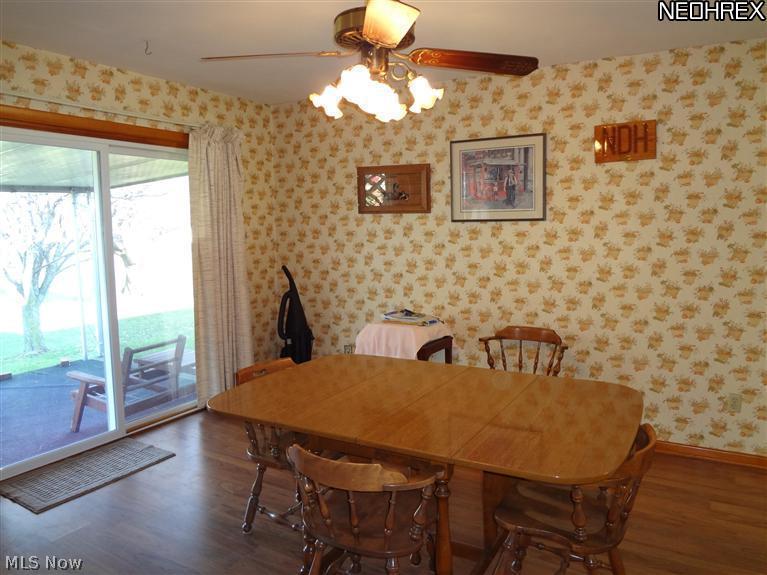 1409 East Strub Road Sandusky, OH 44870 - Photo 7 of 11 Dining area just off the kitchen, wood laminate flooring, newer patio sliding door to the covered back patio.