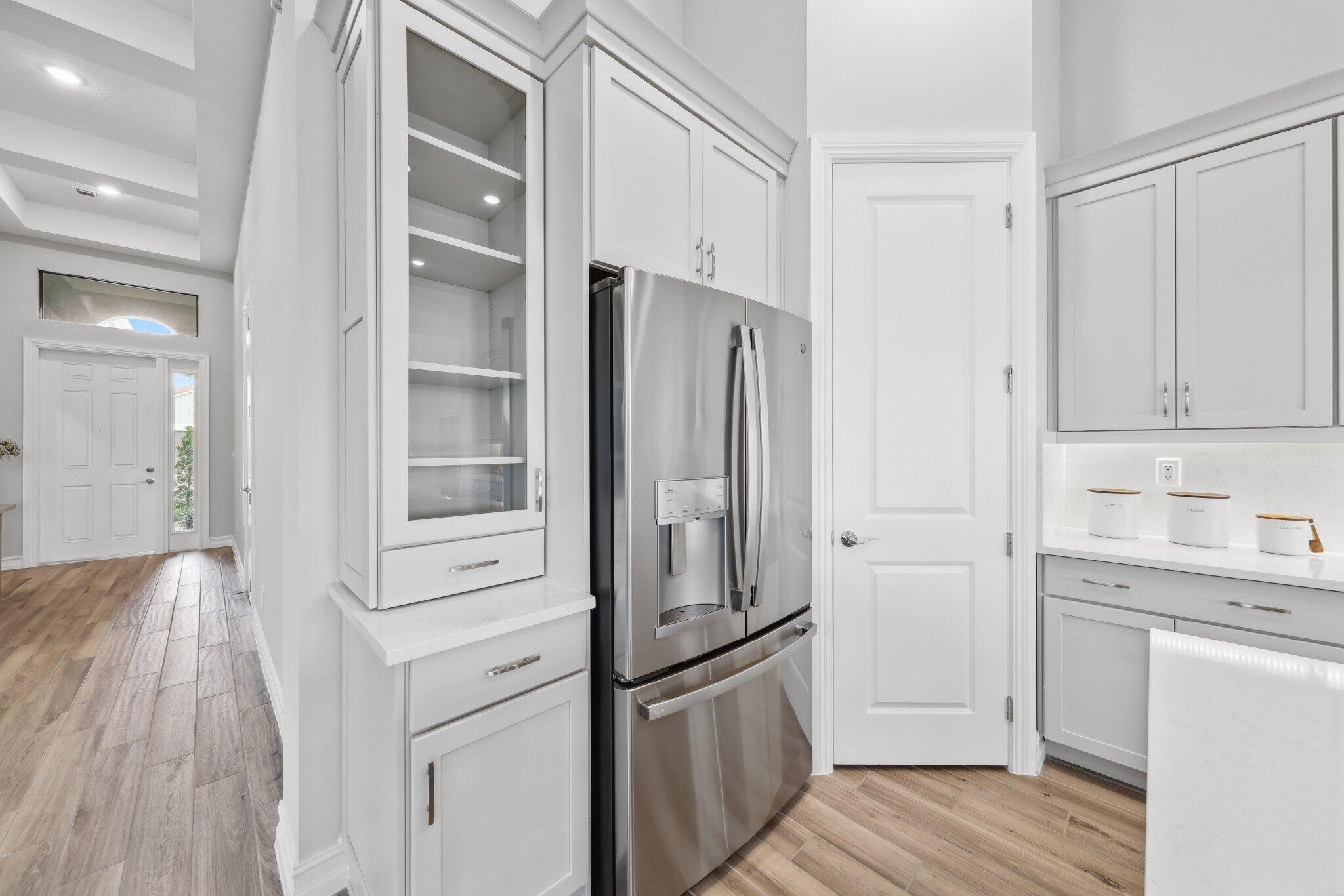 11786 Vivar Run Parkland, FL 33076 - Photo 12 of 46 a kitchen with stainless steel appliances a refrigerator and cabinets