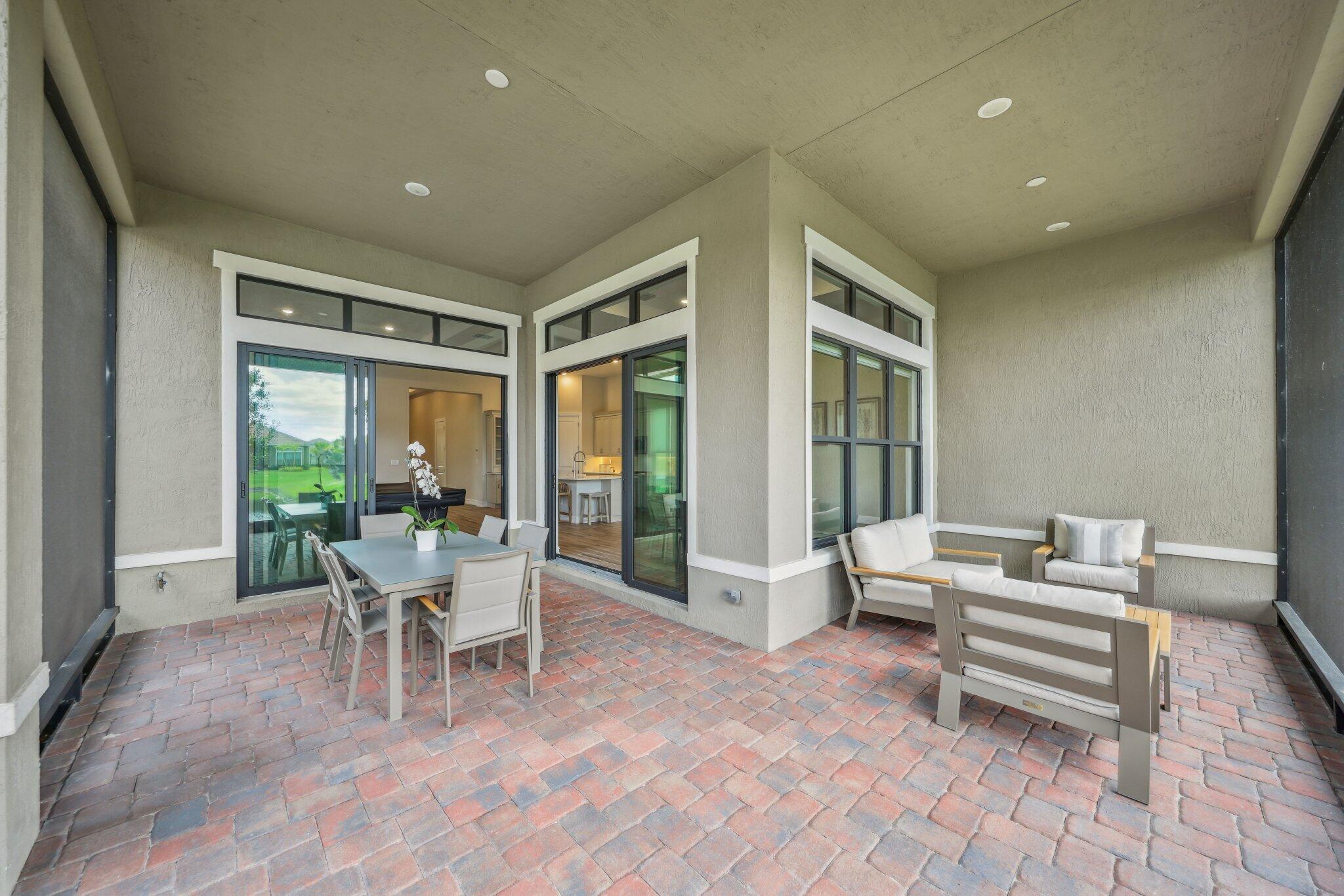 11786 Vivar Run Parkland, FL 33076 - Photo 18 of 46 a dining room with furniture and large windows