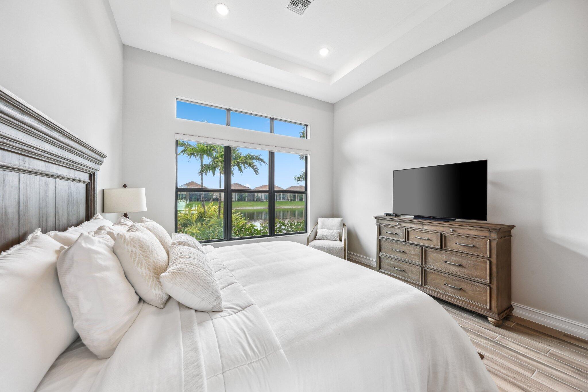 11786 Vivar Run Parkland, FL 33076 - Photo 21 of 46 a bedroom with a bed and a flat screen tv