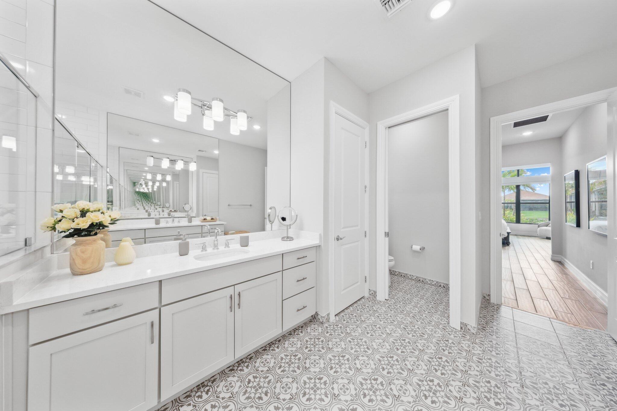 11786 Vivar Run Parkland, FL 33076 - Photo 26 of 46 a spacious bathroom with a double vanity sink a mirror and shower