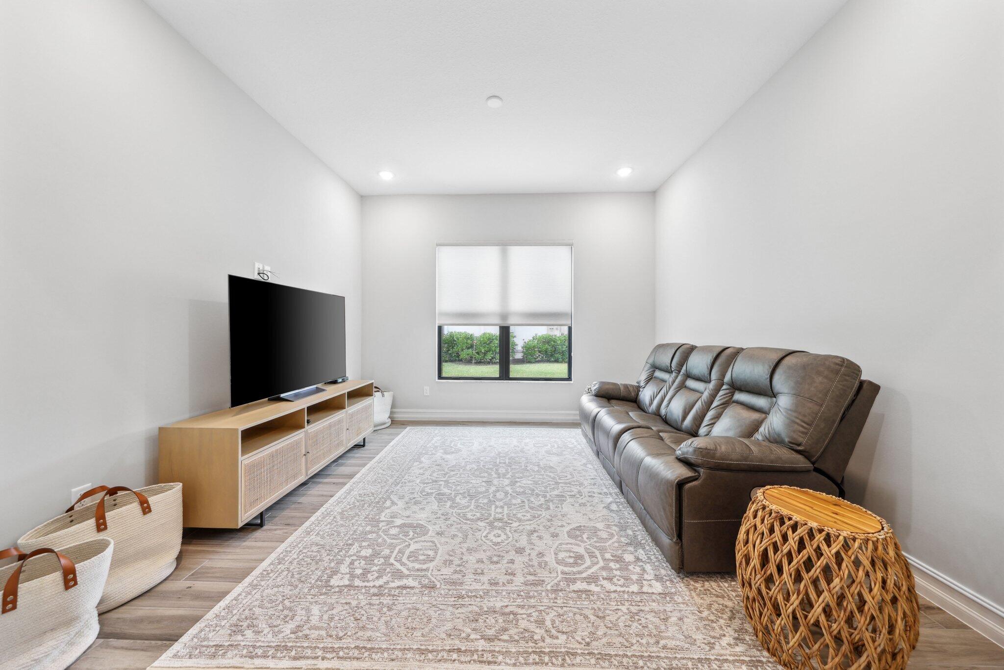 11786 Vivar Run Parkland, FL 33076 - Photo 29 of 46 a living room with furniture and a flat screen tv
