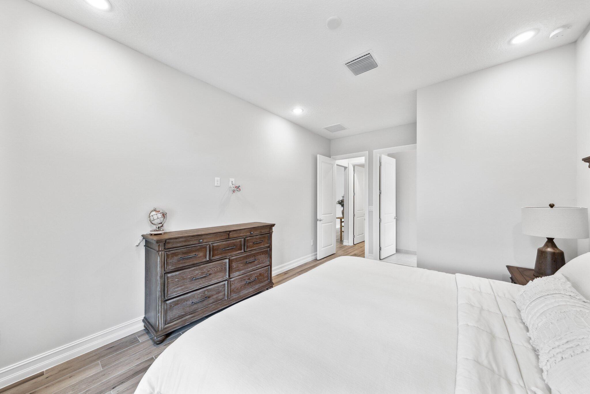 11786 Vivar Run Parkland, FL 33076 - Photo 32 of 46 a bedroom with a bed and cabinets