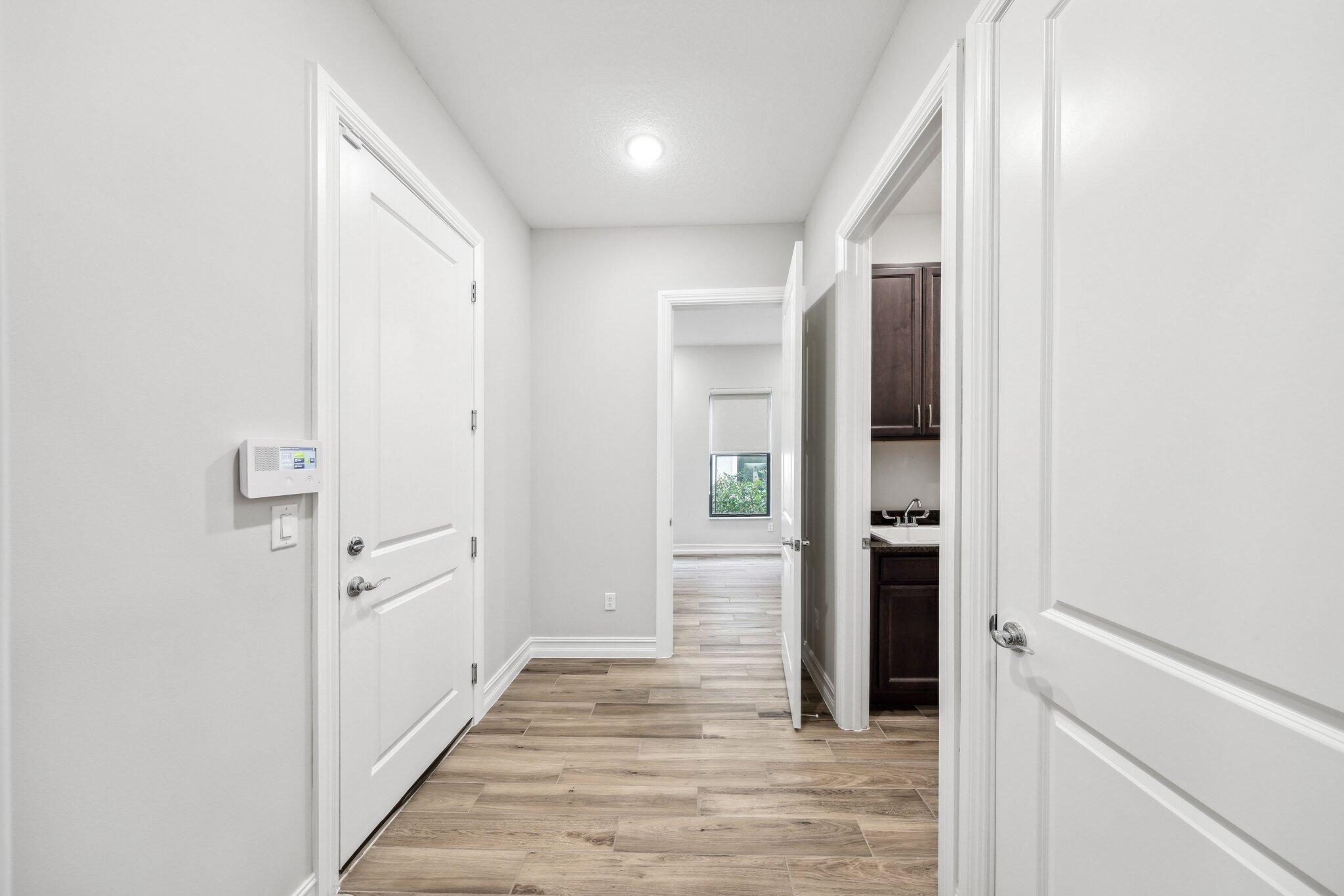 11786 Vivar Run Parkland, FL 33076 - Photo 34 of 46 a view of a hallway with wooden floor and closet