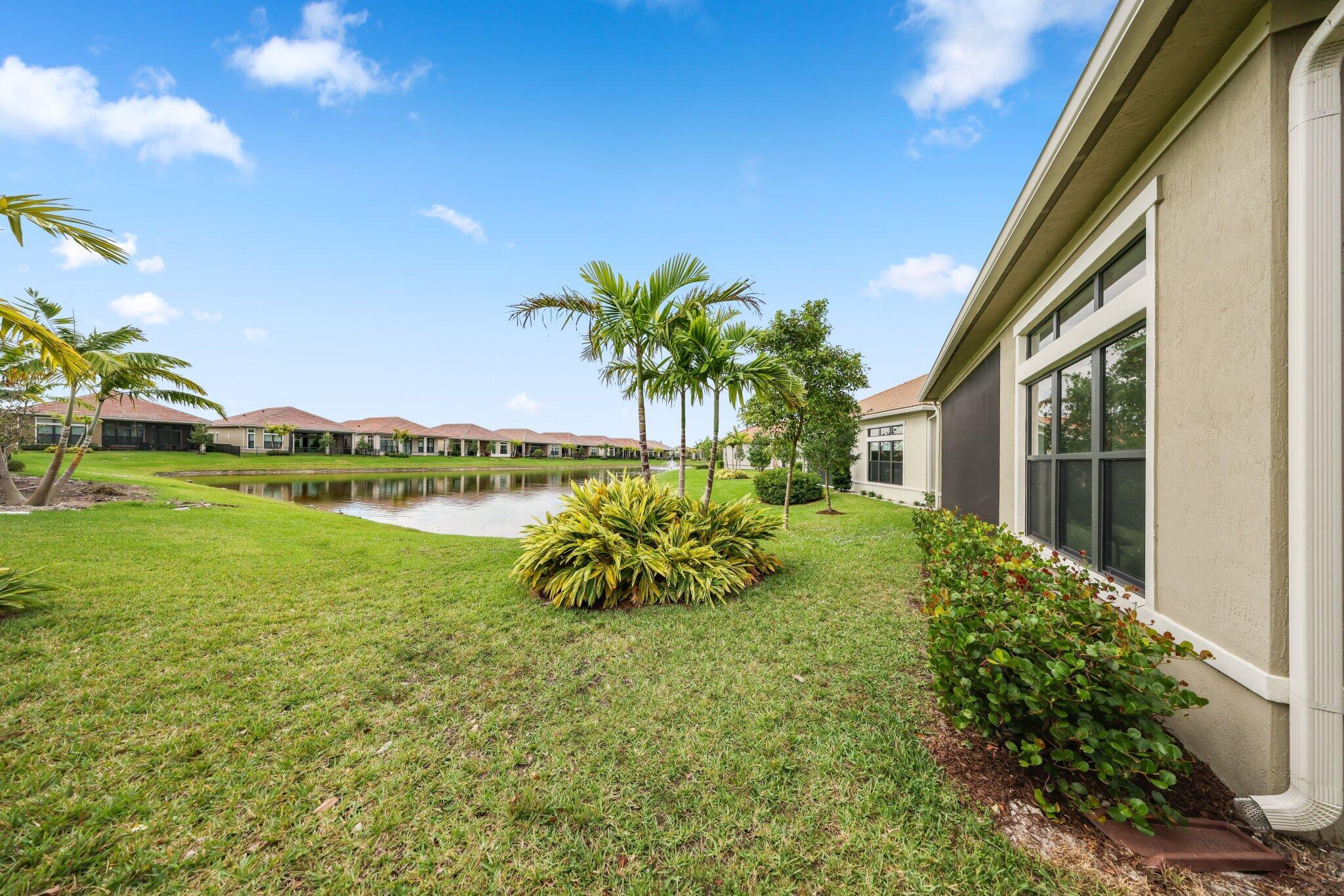 11786 Vivar Run Parkland, FL 33076 - Photo 38 of 46 a view of a garden with a lake