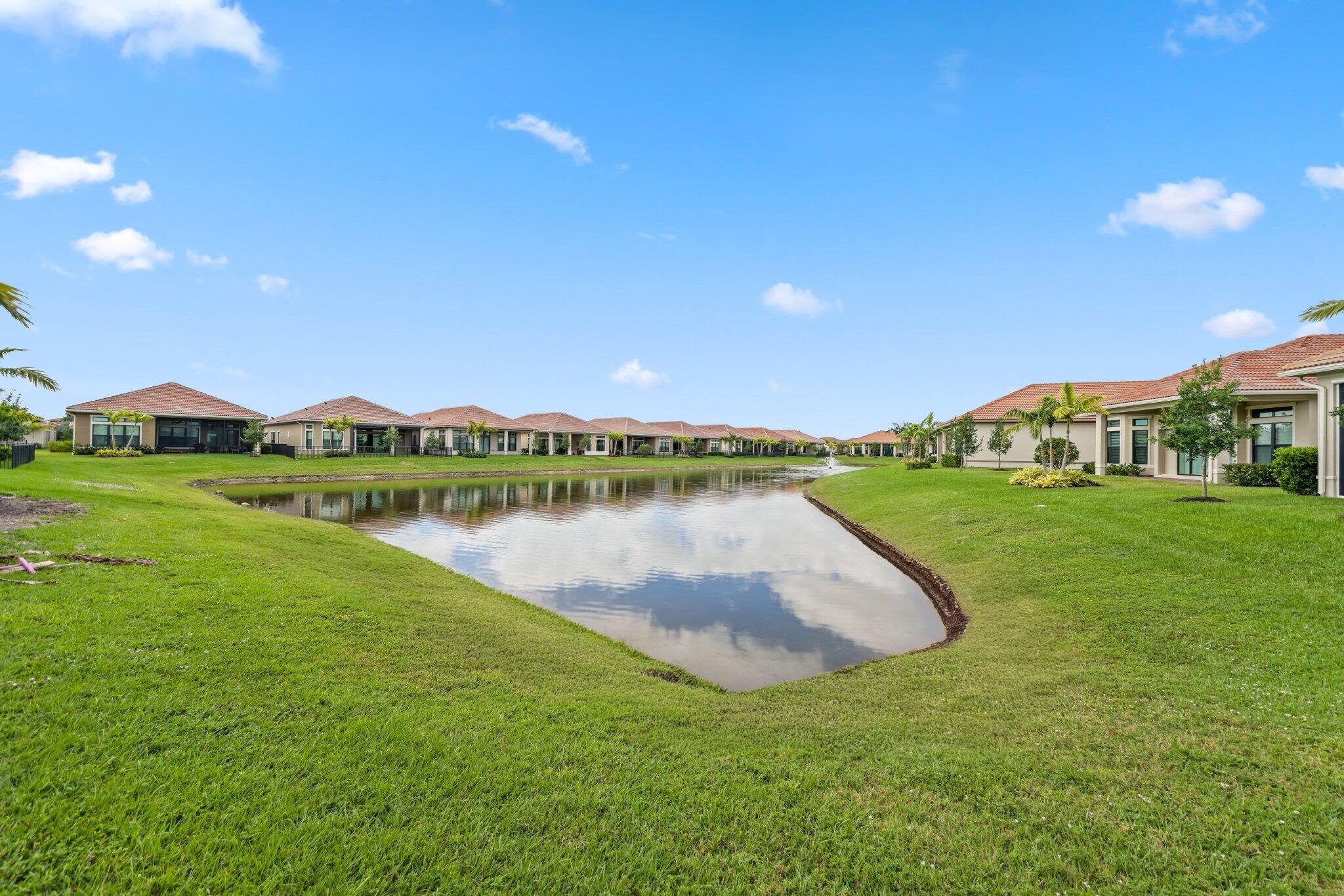 11786 Vivar Run Parkland, FL 33076 - Photo 40 of 46 a view of a lake with houses in the back