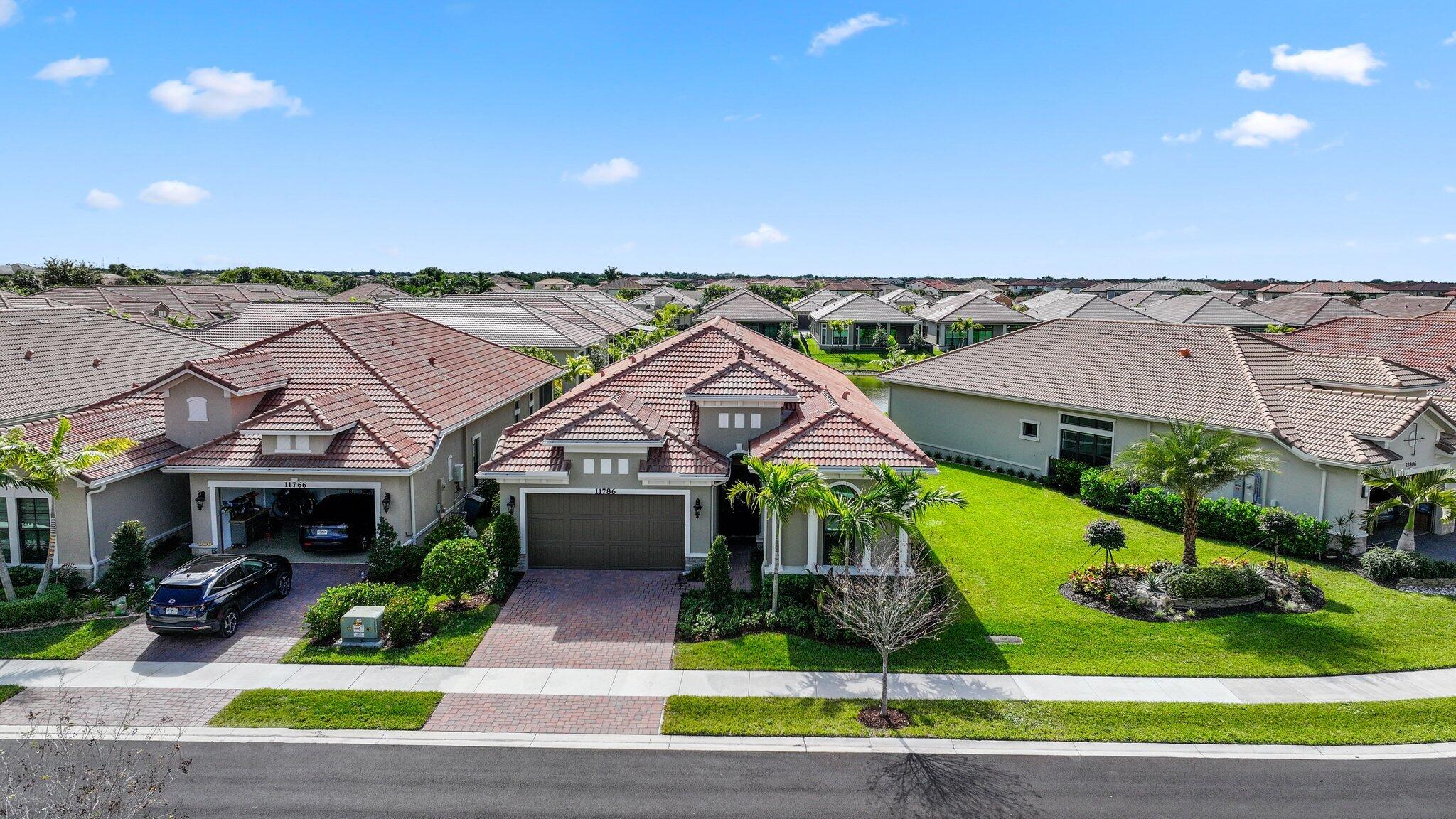 11786 Vivar Run Parkland, FL 33076 - Photo 43 of 46 an aerial view of a house with a garden and plants