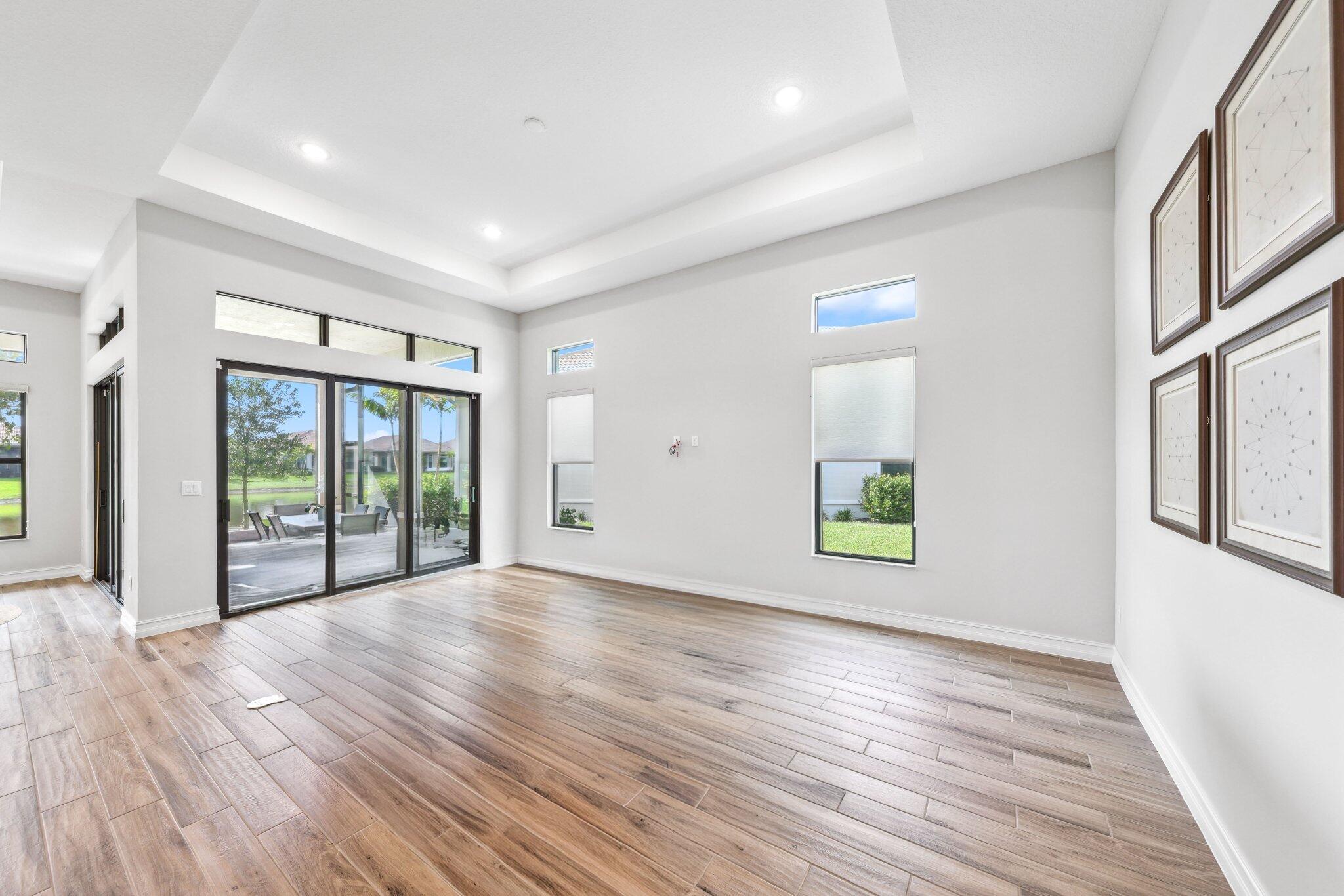 11786 Vivar Run Parkland, FL 33076 - Photo 5 of 46 a view of an empty room with wooden floor and a window