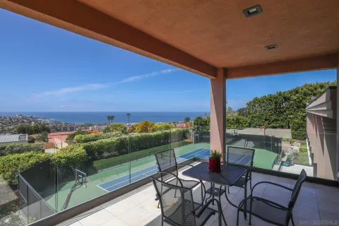 a view of a tennis court with seating area