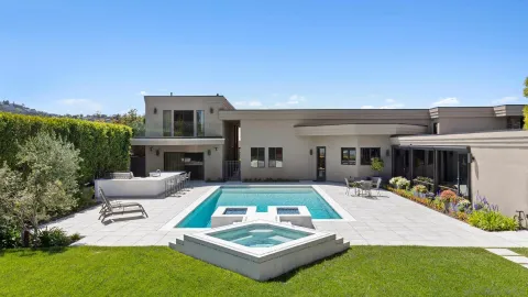a view of house with swimming pool outdoor seating