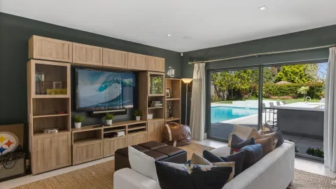 a living room with furniture and a floor to ceiling window