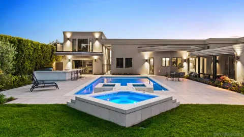 a living room with furniture a flat screen tv and a swimming pool