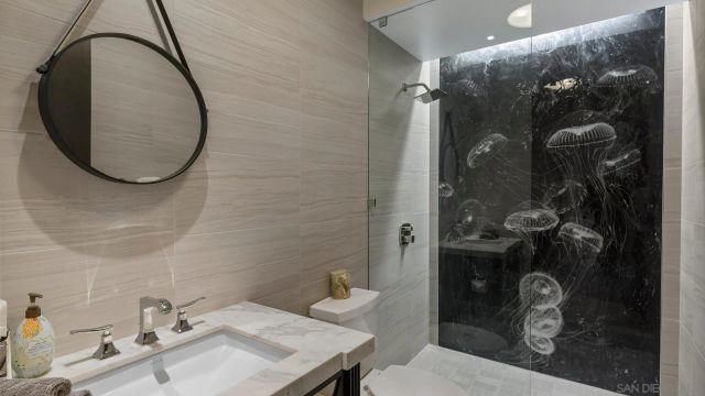 a bathroom with a toilet a sink a mirror and vanity