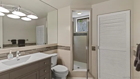 a bathroom with a sink toilet and shower
