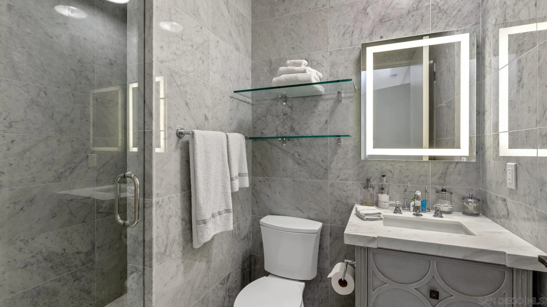 7778 Starlight Drive La Jolla, CA 92037 - Photo 27 of 36 a bathroom with a sink toilet and shower