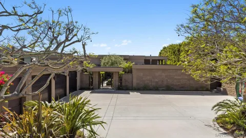 an aerial view of a house with a yard swimming pool and outdoor seating