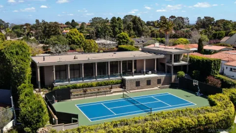 a view of house with swimming pool and outdoor seating
