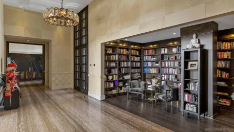 a living room with furniture a fireplace and large windows