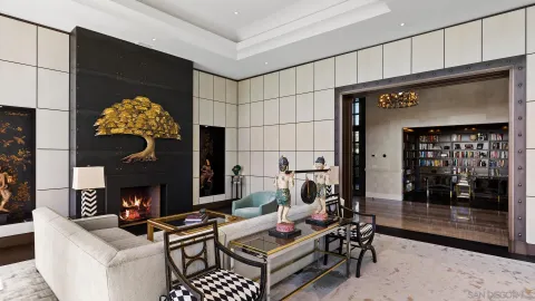 a room with lots of books and a dining table with wooden floor