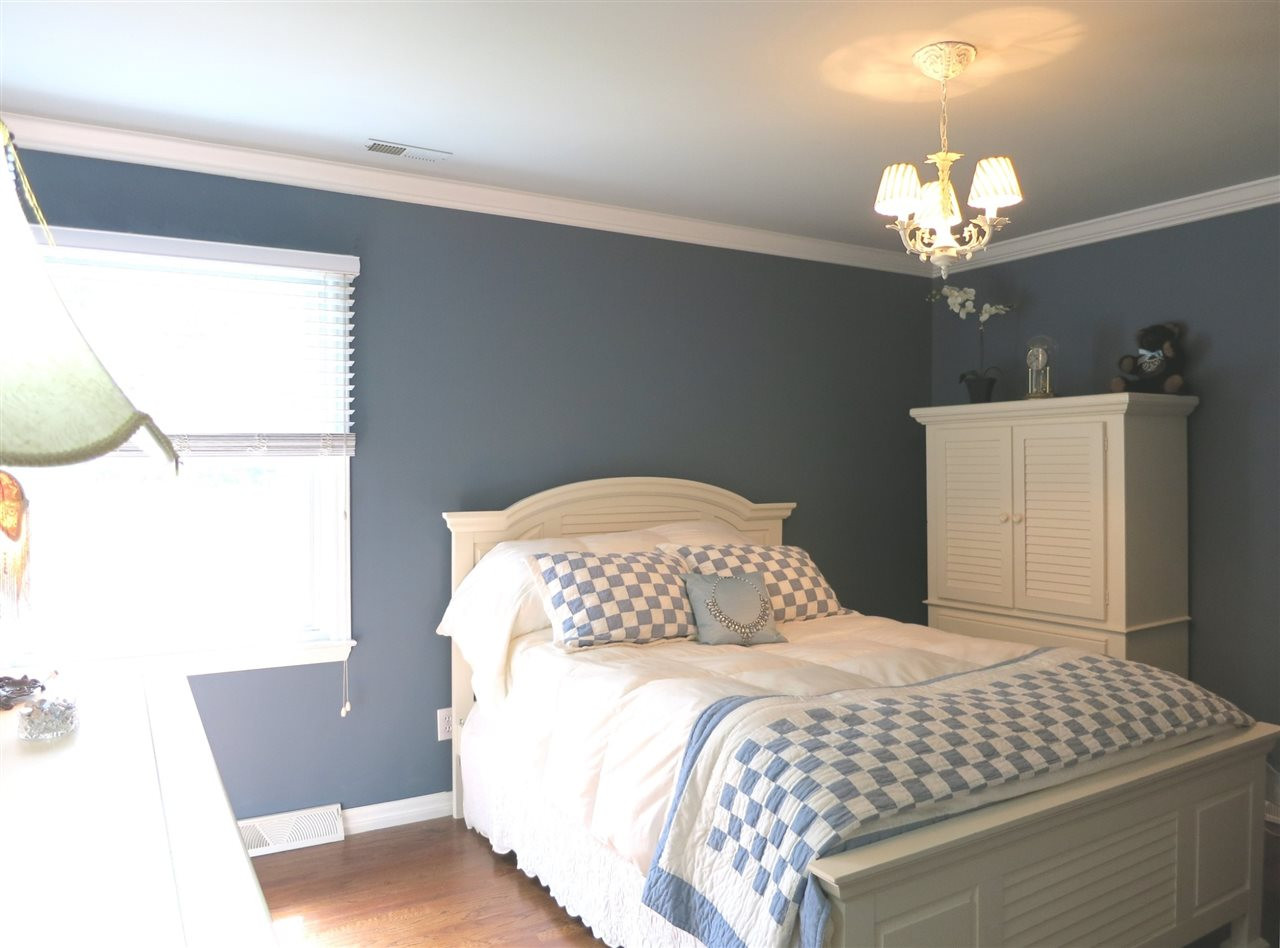 4716 Hiddenbrook Drive Raleigh, NC 27609 - Photo 16 of 25 Bedroom 2 has a hardwood floor, CF, big closet, crown molding & its own private Bath. Bedroom