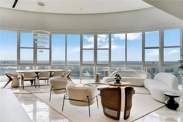 a view of a dining room with furniture and a floor to ceiling window