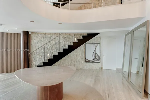 a view of a dining room with furniture large window and outside view