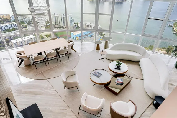 a living room with furniture and a floor to ceiling window