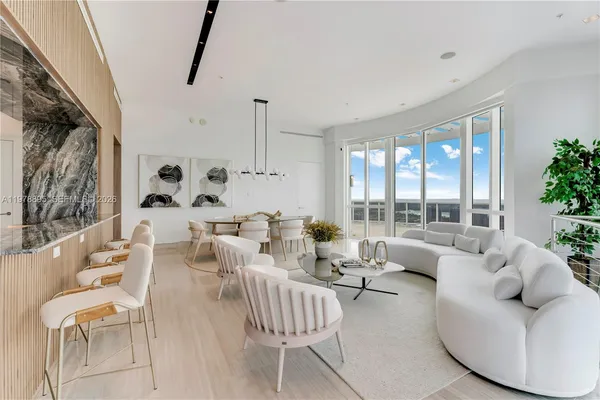 a bedroom with a bed and glass walk in closet