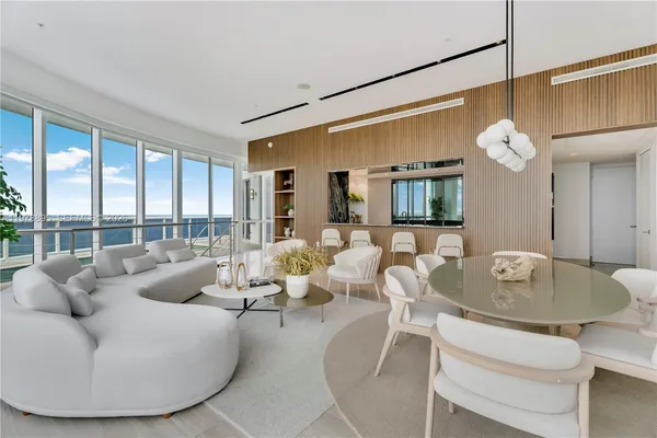 view of living room with furniture and floor to ceiling window